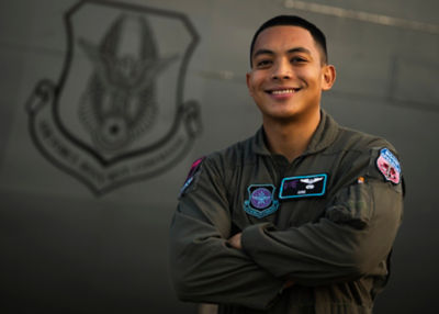 Female Airman posing in front of an aircraft